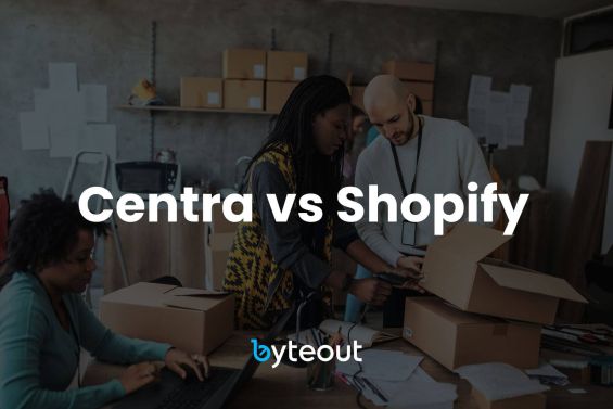 Blog cover image: A team of individuals is working together in a modern office space filled with boxes and packing materials. The text "Centra vs Shopify" is prominently displayed in bold white letters across the center of the image, with the "byteout" logo at the bottom, indicating a comparison of these two ecommerce platforms.